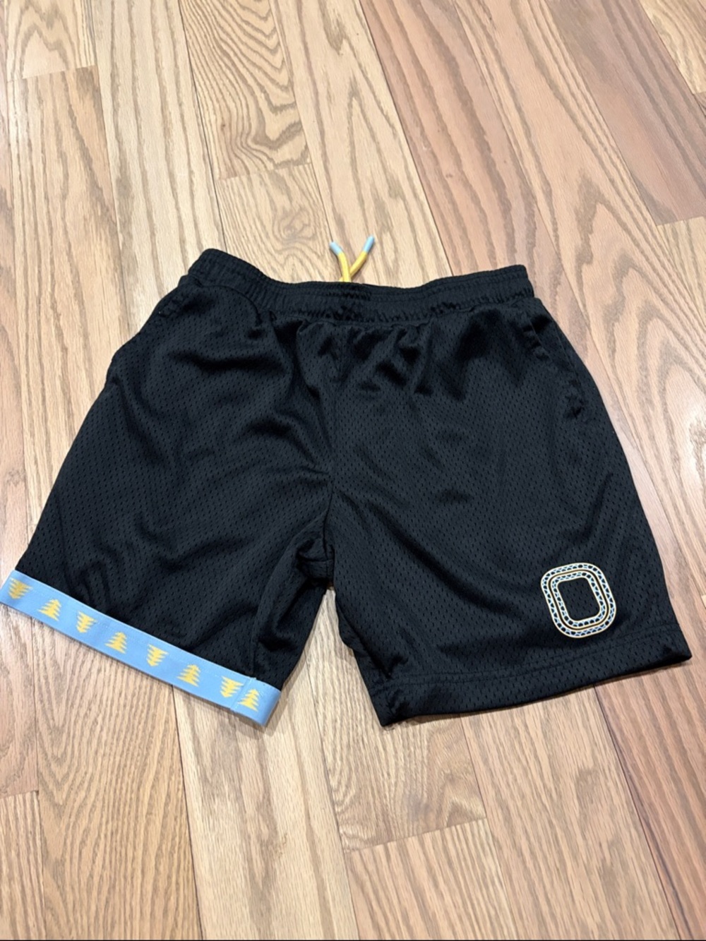 Kids Black Mesh Shorts with Blue Trim and Yellow Tree Detail